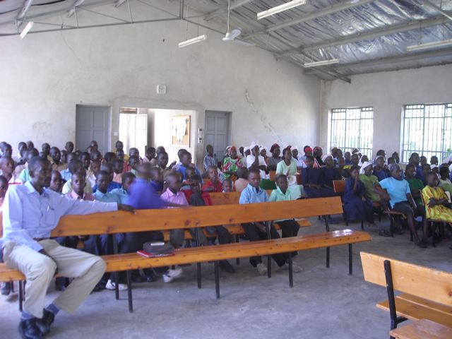 Orphans and guardians gather for spiritual teaching prior to the Christmas meal.