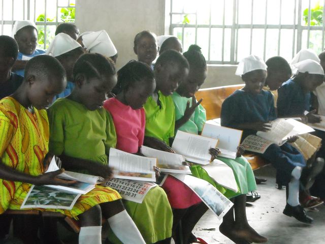 Orphans are thrilled to look at their new Christmas gift, a 101 Favorite Bible story book. 