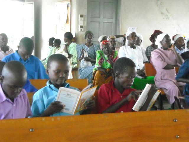 Orphans are thrilled to look at their new Christmas gift, a 101 Favorite Bible story book. 