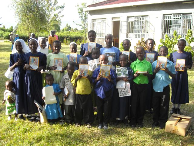 A group of orphans poses with their books and a calander